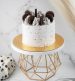 cake with oreo biscuits on top and golden cake stand